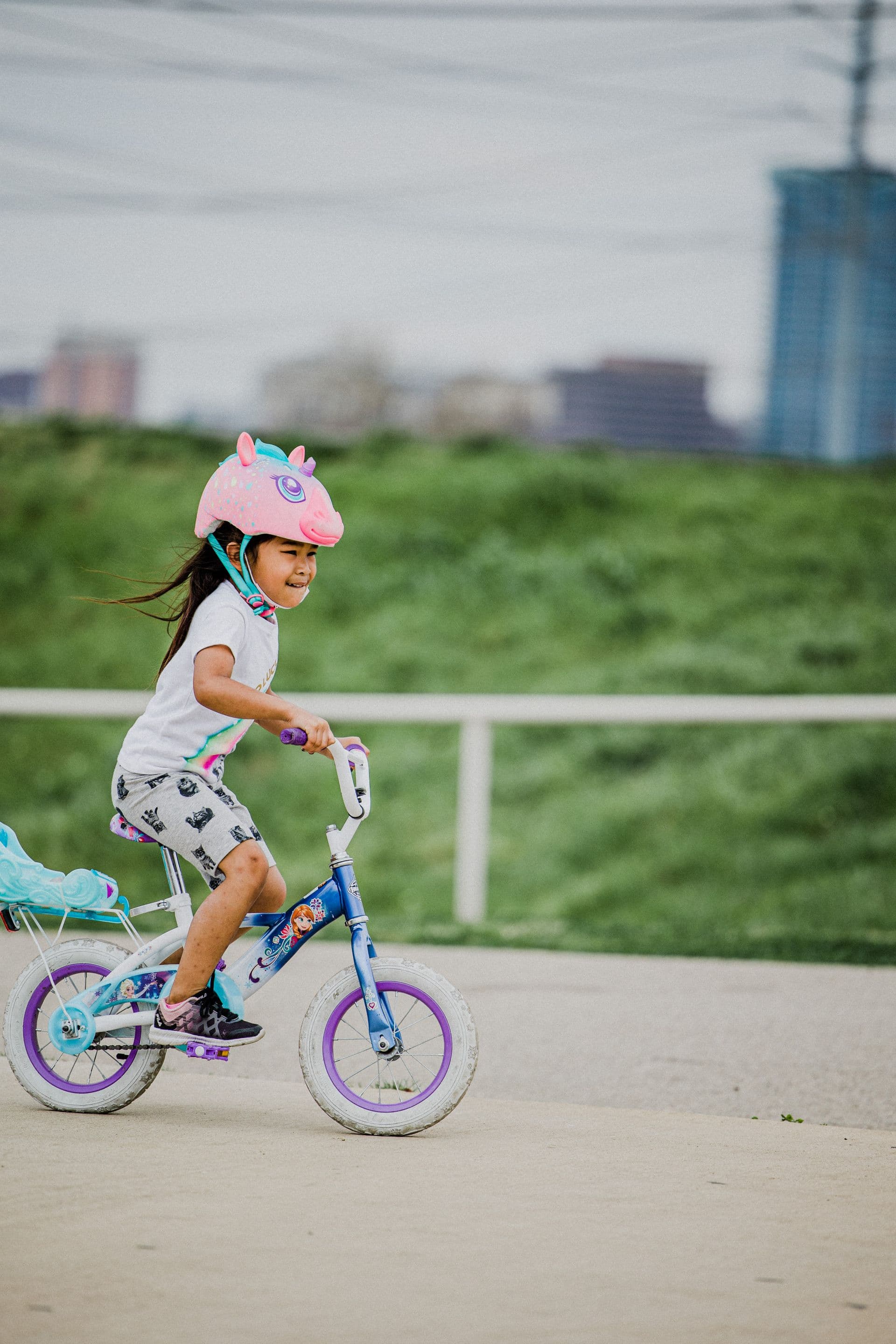 A young girl riding her bike along a neighborhood street